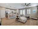 Open-concept living room and kitchen area with modern finishes and lots of natural light at 690 Monroe Hill Pl, Henderson, NV 89011