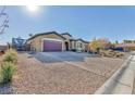 Well-maintained home with a brick driveway and desert landscaping at 7143 Nodding Thistle Ct, Las Vegas, NV 89178