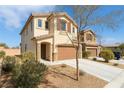 Two-story home featuring desert landscaping, a tile roof, and a two-car garage at 7722 Sagamore Bay Ct, Las Vegas, NV 89179