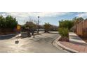 A well-manicured community entrance with lush landscaping and signage at 9293 Boltonia Ct, Las Vegas, NV 89149