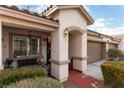 Inviting home exterior with a covered porch and a two-car garage at 9293 Boltonia Ct, Las Vegas, NV 89149