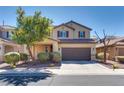 Beautiful two-story home with desert landscaping, complemented by a spacious two-car garage at 933 Monte Nerone Ave, Henderson, NV 89012