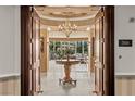 Elegant foyer with chandelier, custom table, and beautiful entrance at 1 Hughes Center Dr # 308, Las Vegas, NV 89169