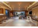 Bright living room with floor-to-ceiling windows, modern lighting, and a bar area for entertaining guests at 1 Hughes Center Dr # 308, Las Vegas, NV 89169
