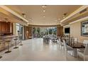 Expansive open-plan living room featuring a wet bar, dining area, and plush seating with floor-to-ceiling windows at 1 Hughes Center Dr # 308, Las Vegas, NV 89169