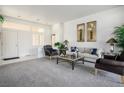 Bright living room featuring neutral tones, comfortable seating, and abundant natural light at 10132 Cresent Creek Dr, Las Vegas, NV 89134