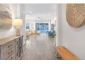 Bright entryway with hardwood floors leading to an open-concept living area at 106 Reflection Bay Dr, Henderson, NV 89011