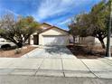 Inviting single-story home featuring a spacious driveway and low maintenance landscaping at 11036 Parete Ct, Las Vegas, NV 89141