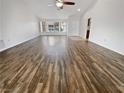 Spacious living room showcasing hardwood floors, a large window, and neutral walls at 2456 Palmridge Dr, Las Vegas, NV 89134