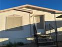 Exterior view of a home featuring access stairs leading up to the front entrance at 2471 Mcmurray Dr, Pahrump, NV 89060