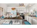 Bright kitchen featuring white cabinets, butcher block island, and modern appliances for efficient cooking at 266 Corvallis Ct, Henderson, NV 89074