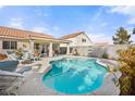 Inviting pool area with lounge chairs and manicured landscaping, perfect for relaxing and entertaining outdoors at 266 Corvallis Ct, Henderson, NV 89074