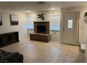 A cozy living room features a brick fireplace and tile floors, perfect for relaxing and entertaining at 2692 Matogroso Ln, Las Vegas, NV 89121