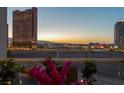 Balcony featuring pink flowers, clear railings, and an impressive view of the Las Vegas skyline at 2747 Paradise Rd # 404, Las Vegas, NV 89109