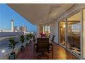 Spacious balcony with dining table and chairs, offering a view of the Stratosphere Tower at 2747 Paradise Rd # 404, Las Vegas, NV 89109
