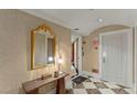Elegant condo hallway with decorative mirror, and stylish tile flooring at 2747 Paradise Rd # 404, Las Vegas, NV 89109