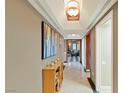 View of hallway with marble floors, art and a glimpse of the living room at 2747 Paradise Rd # 404, Las Vegas, NV 89109