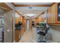 Modern kitchen featuring wood cabinets, granite counters, updated appliances and breakfast bar at 2747 Paradise Rd # 404, Las Vegas, NV 89109