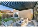 Cozy covered patio with fire pit, perfect for outdoor relaxation and entertaining at 3192 Bormida Ave, Henderson, NV 89044