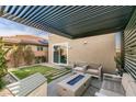 Cozy covered patio with fire pit, perfect for outdoor relaxation and entertaining at 3192 Bormida Ave, Henderson, NV 89044