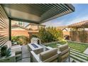 Backyard features a covered patio, fire pit, dog house, and lush landscaping at 3192 Bormida Ave, Henderson, NV 89044