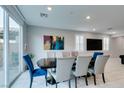 Dining room with seating for eight, a large window, and stylish artwork at 3192 Bormida Ave, Henderson, NV 89044