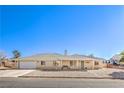 Charming single-story home featuring a gravel yard and a tile roof under a clear blue sky at 3192 Taylor St, Logandale, NV 89021