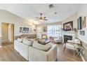 Bright living room features a fireplace, ceiling fan, wood flooring, and comfortable seating at 3192 Taylor St, Logandale, NV 89021