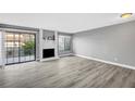Spacious living room boasting wood floors, natural light, and cozy fireplace at 3449 Lorilou Ln # 2, Las Vegas, NV 89121