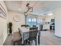 Cozy dining area adjacent to kitchen, featuring stylish lighting and stainless steel appliances at 3665 Bronco Rd, Las Vegas, NV 89103