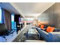 Open-concept living room showcasing modern furniture, a sleek fireplace, and views of the city at 4381 W Flamingo Rd # 2322/2320, Las Vegas, NV 89103