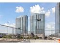 Condominium building exterior shot, framed by a chain link fence on an overcast day at 4525 Dean Martin Dr # 607, Las Vegas, NV 89103