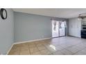 Neutral living room showing tile flooring, sliding glass door, and white cabinets at 5239 Elgin Cir, Las Vegas, NV 89122