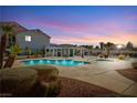 Community pool area with mature landscaping, shade pergola, and lounge chairs at 6201 E Lake Mead Blvd # 156, Las Vegas, NV 89156