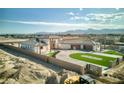 Expansive aerial view of new construction home with stylish driveway, minimalist landscaping and mountain views at 6383 Horse Dr, Las Vegas, NV 89131