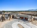 Stunning view of a desert estate under construction with mountain range in background at 6383 Horse Dr, Las Vegas, NV 89131