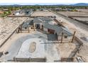 Desert home under construction featuring custom circular driveway and wood garage doors at 6383 Horse Dr, Las Vegas, NV 89131