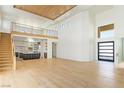 Open concept living space featuring soaring ceilings, staircase, and an inviting kitchen with modern accents at 6383 Horse Dr, Las Vegas, NV 89131