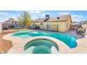 Beautiful in-ground pool with a connected hot tub and fenced-in yard at 6408 Starcrest Dr, Las Vegas, NV 89108