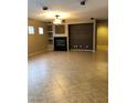 Spacious living room featuring a fireplace, tile flooring, and built-in shelving, perfect for entertaining at 6816 Royal Poinciana Ct, Las Vegas, NV 89131