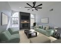 Bright living room with arched windows, modern fireplace, and contemporary furnishings at 9808 Eagle Rock Ct, Las Vegas, NV 89117