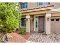 Inviting entryway with well-manicured landscaping, stone accents, and stylish lighting enhancing curb appeal at 9876 Parador Cellars Ct, Las Vegas, NV 89141