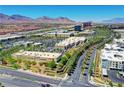 Aerial view of a commercial area with retail stores, restaurants, and palm tree-lined streets at 10217 Queens Church Ave, Las Vegas, NV 89135