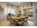 Cozy dining area with a round table, patio access, and stylish decor at 10217 Queens Church Ave, Las Vegas, NV 89135