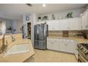 Bright kitchen featuring white cabinetry, stainless steel appliances, and a pantry at 10217 Queens Church Ave, Las Vegas, NV 89135