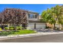 Charming two-story home featuring a balcony, manicured lawn, and a three-car garage at 10662 Bonchester Hill St, Las Vegas, NV 89141