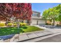 Charming two-story home featuring a well-maintained lawn, mature trees, and a three-car garage at 10662 Bonchester Hill St, Las Vegas, NV 89141