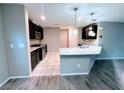 Modern kitchen featuring dark cabinetry, stainless steel appliances, granite countertops, and pendant lighting at 10941 Prudhoe Bay St, Las Vegas, NV 89179