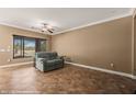 Cozy living room with tile flooring, ceiling fan, and large window overlooking the yard at 1455 Waterfall Ln, Mesquite, NV 89034