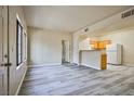 Bright and airy open-plan living room and kitchen with wood-look floors at 2131 Hussium Hills St # 104, Las Vegas, NV 89108